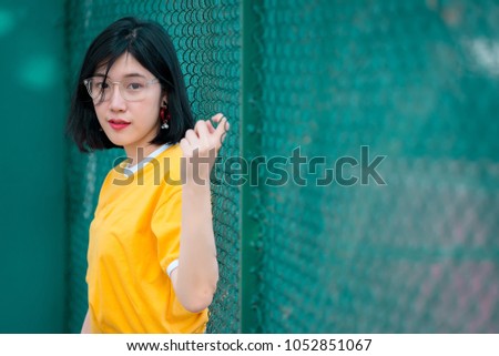 Portrait of beautiful asian chic girl pose for take a picture,Lifestyle of teen thailand people,Modern woman happy concept,Tennis couse, pastel tone