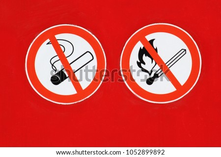 the sign "it is forbidden to smoke" and the sign "it is forbidden to make fire" on a red background
