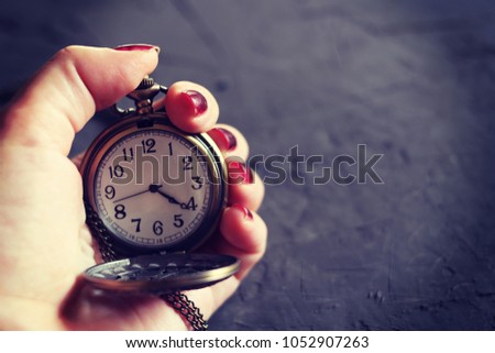 Woman's hand holding watch. Time management concept.