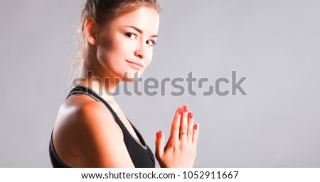 Young woman sitting on the floor in lotus position 