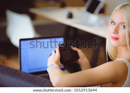 Young photographer and graphic designer at work