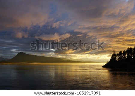 Twilight at Canadian Jonstone Strait with magical golden clouds