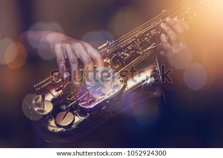 close up of saxophone player plays saxophone  with music concert light and Bokeh on stage Royalty-Free Stock Photo #1052924300