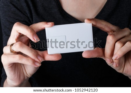 mock up. white card in young hands