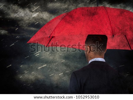 Digital composite of Back of business man with umbrella against rain and clouds with grunge overlay