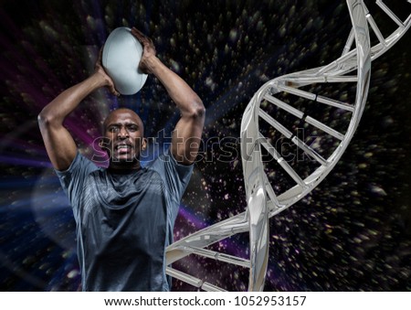 Digital composite of rugby player with ball, iron dna chain and black background