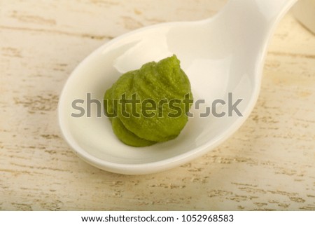 Spicy Wasabi sauce in the bowl over wooden background
