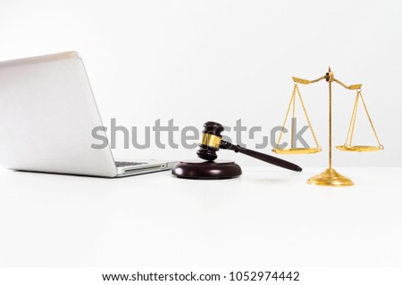 Close up wooden gavel of lawyer in white courtroom.