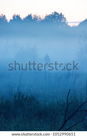 Silhouette of an adult man in a fog