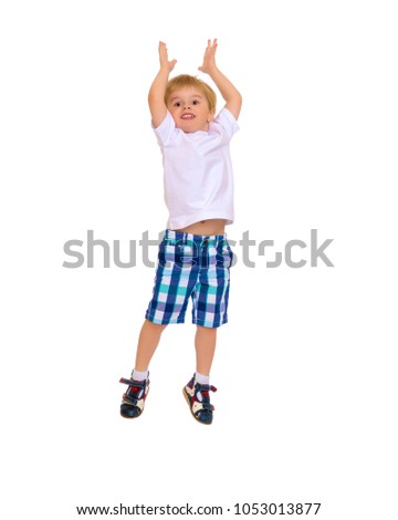 Little boy jumping fun in the studio on a white background. The concept of a happy childhood, sports and fitness. Isolated.