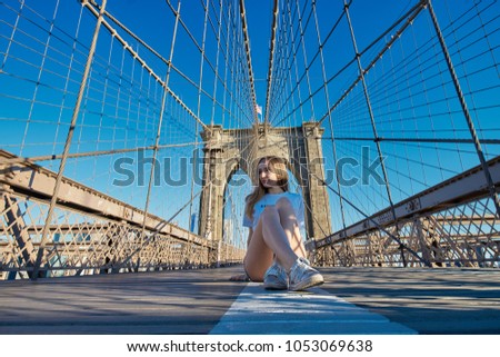 Beautiful longhaired girl on Brooklyn Bridge, New York   