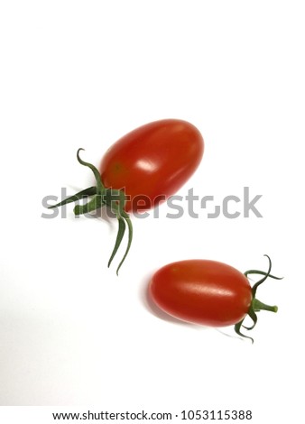 two Cherry Tomatoes isolated from white background. ripe tomatoes  with  red color and green fruit stem.