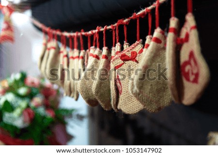 A close picture of Christmas hand made socks hanging on a fireplace.