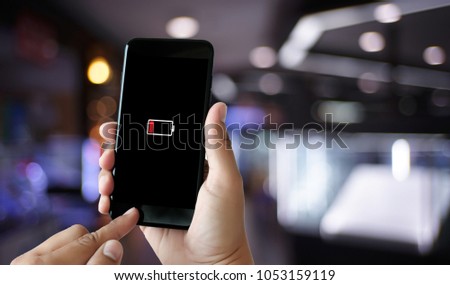 Close up man hands using smart phone battery low charged battery screen
