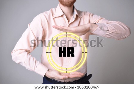 In the hands of a businessman, a neon circle with the inscription:HR