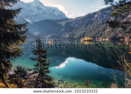 Wonderful summer landscape. Sunny day in Alps. Incredible mountain lake Eibsee in Autumn. Popular locations for Photographers. Natural background. Garmisch-Partenkirchen. Bavarian alp, Germany. Europe