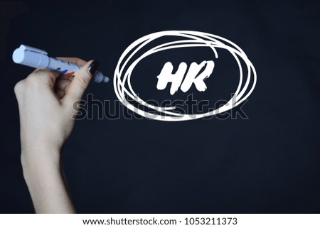 The businessman writes an inscription with a white marker:HR