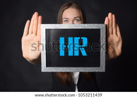 In the hands of a businessman a frame with the inscription:HR