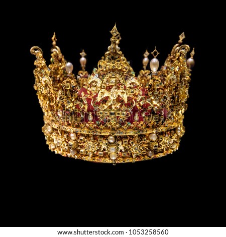 Golden crown with gems isolated on black background. Royalty-Free Stock Photo #1053258560