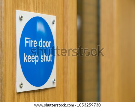 Fire Door Keep Shut Sign on a Wooden Fire Door