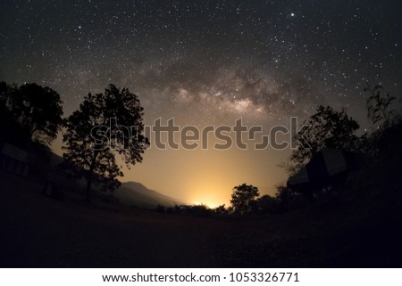 Milky way galaxy brightening in the night sky over the mountain.