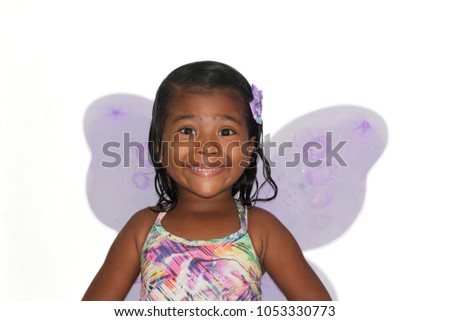 portrait of black child dressed as fairy and smiling isolated.