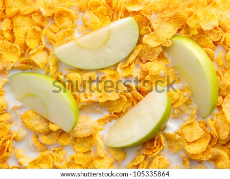 Some apple slices with cereals for breakfast concepts. Cornflakes with milk
