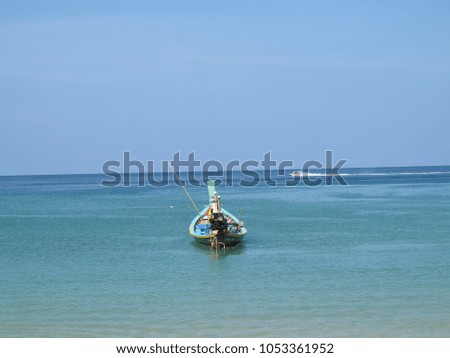 Boat floating on the blue ocean ,sea and blue sky.