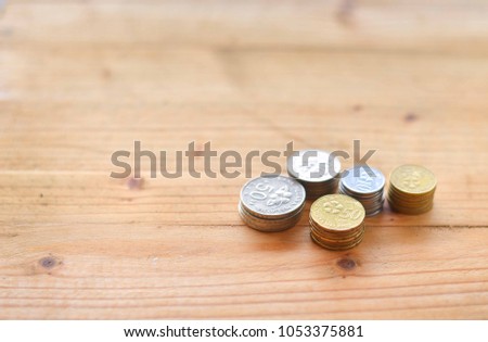 Malaysian coins on wooden background with text space. selective focus.
