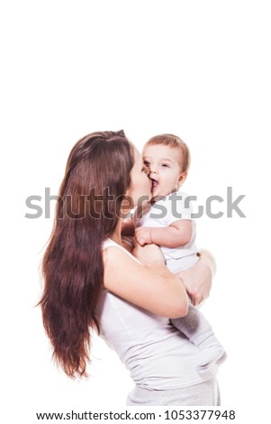 Mother kisses baby.