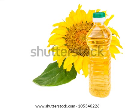Blooming sunflowers and a bottle of vegetable oil. The photo on white background