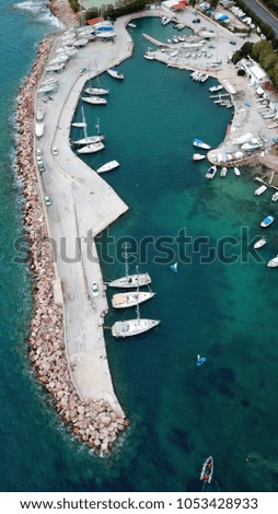 Aerial drone photo of tropical clear water port with small boats docked