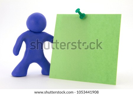 Blue plasticine character and green sticker. Stationery. Isolated over white background