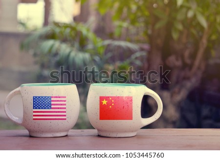 United State of America and China Flag on two tea cups with blurry background