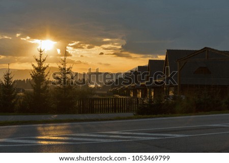 wooden cottages town at dramatic sunset