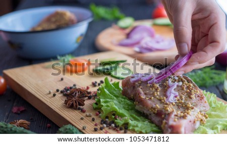The process of cooking a steak, with all the ingredients on the table, selective focus