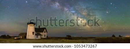 A panoramic view of the Milky Way Galaxy over Stage Harbor Lighthouse at Hardings Beach in Chatham, Massachusetts.