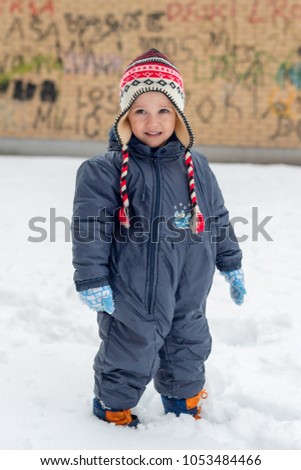 the boy is walking in the snow