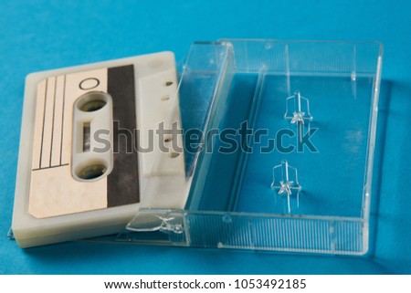 Blank cassette tape box on blue background. Vintage cassette tape case with retro cassette mockup. Plastic analog magnetic clear packaging template. Mixtape box open 