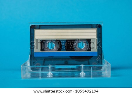 Blank cassette tape box on blue background. Vintage cassette tape case with retro cassette mockup. Plastic analog magnetic clear packaging template. Mixtape box open 
