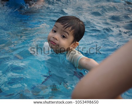 Thai toddler swimming in the pool 