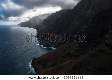 A photo taken from a helicopter of the Na Pali Coast in the early morning light. 