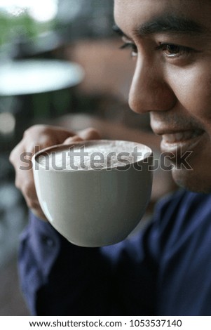 A man drinking a hot coffee in coffee shop