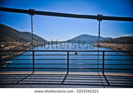 Black steel bridge and concrete in a large dam