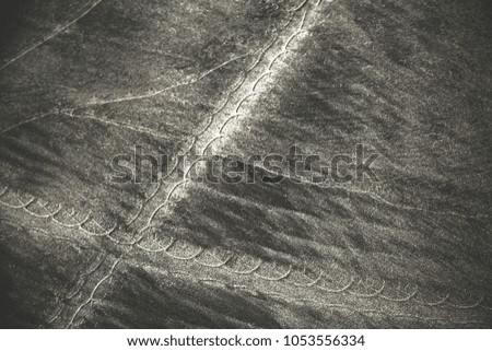 Tyre track on dirt sand or mud. Picture in retro or grunge tone. Just drive on sand and have off road track.