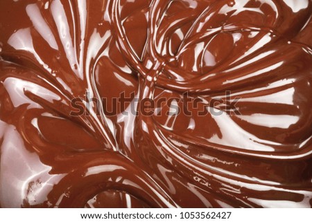 Melted chocolate swirl as a background closeup.