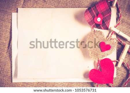 Handmade love hearts and sheets of blank paper 