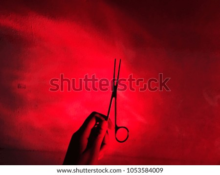 Red light with hand that hole the scissors.