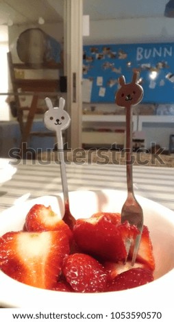 strawberry in the bowl with mini rabbit fork