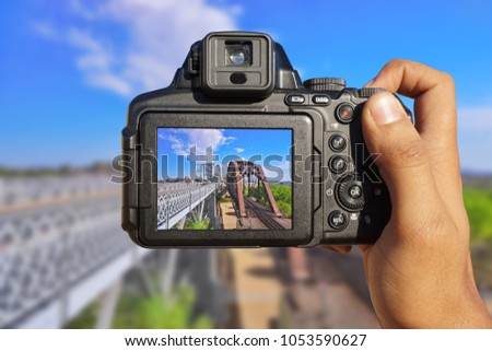 Camera in hand shooting two bridges in a state line between Arizona and California